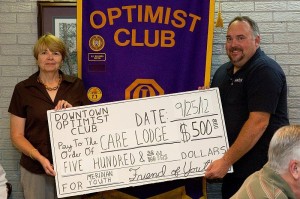 Care Lodge Director Leslie Payne is presented with a donation by DTOC President Eddy Chaney