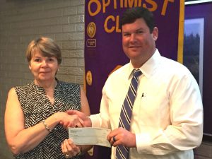 Director Leslie Payne receives a donation from DTOC President Daniel Stewart